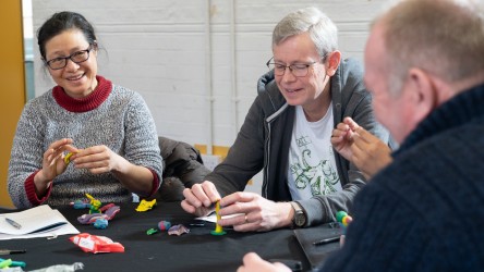 Education ambassadors in discussion while creating claymation characters