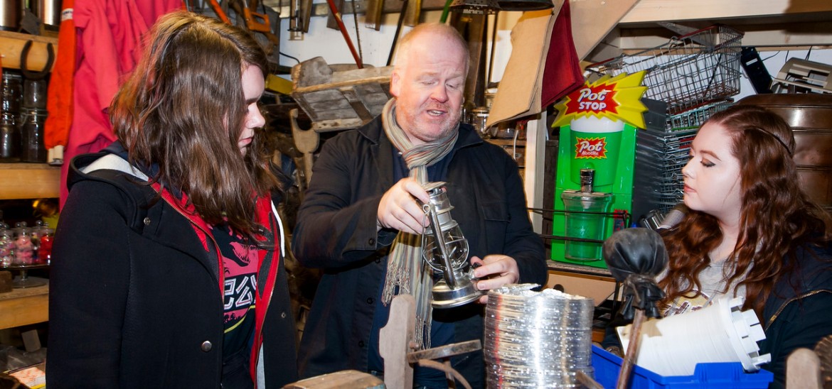 Props master showing students an old lantern during a Screenworks session